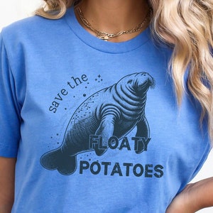 May include: A blue t-shirt with a graphic of a manatee and the text "save the floaty potatoes".