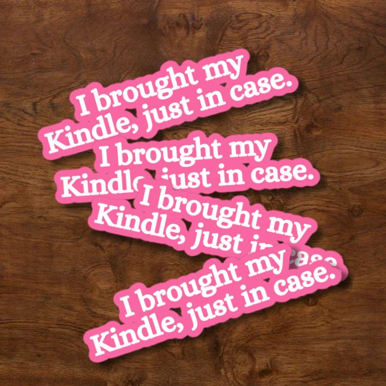 May include: A collection of four identical die-cut stickers featuring a bright pink background with white text that reads, I brought my Kindle, just in case. The stickers are arranged in a staggered, overlapping pattern across the frame.