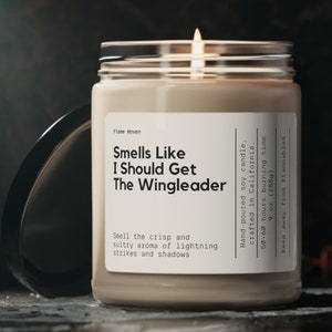 May include: A glass jar candle with a white label that reads "Smells Like I Should Get The Wingleader". The candle is hand-poured soy and crafted in California. It has a burn time of 50-60 hours and is 9 ounces.