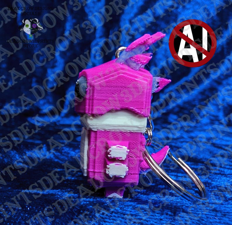 May include: A 3D-printed keychain featuring a stylized creature with a bright pink head and body, white accents on the chest and sides, and a metallic silver ring attached to the top. The figure has a blocky, geometric design with visible layer lines.