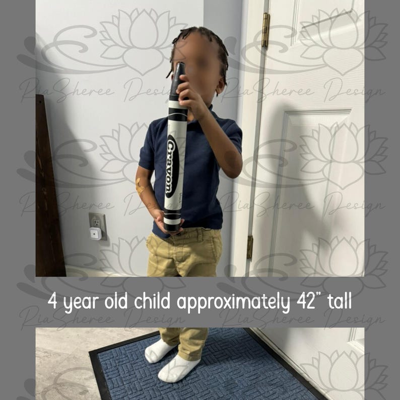A 4 year old child approximately 42 inch tall holding a 15 inch black crayon prop for scale.