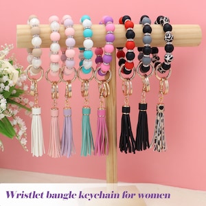Llavero de silicona para mujer, pulsera elástica con cuentas, llavero con circonita y borla para regalo del día de la mujer