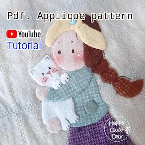 Könnte beinhalten: Ein PDF-Applikationsmuster für ein Mädchen, das eine weiße Katze hält. Das Mädchen trägt ein grün-weiß kariertes Hemd, einen gelben Hut und einen lila Rock. Das Muster enthält einen Link zu einem YouTube-Tutorial. Das Bild stammt von Happy Quilt Day.