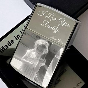 May include: Silver lighter with a photo of a young girl and the engraved text "I Love You Daddy Love Allison".