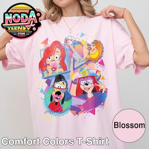 Könnte beinhalten: Hellrosa Comfort Colors T-Shirt mit einem farbenfrohen Cartoon-Motiv. Das Design zeigt vier Cartoon-Charakterporträts mit geometrischen Formen und den Text "Comfort Colors T-Shirt" am unteren Rand. Das Wort "Blossom" ist in einem Kreis.
