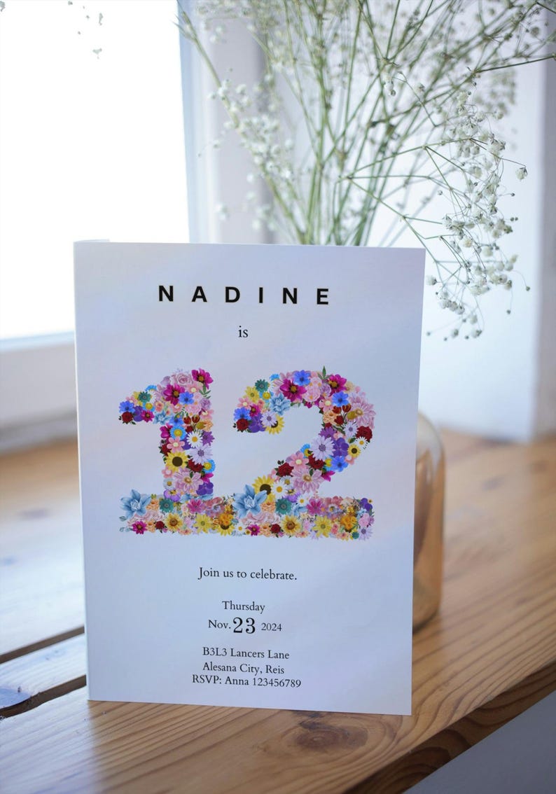 May include: A white invitation card with the text "NADINE is 12" in black font. The number 12 is made of colorful flowers. The invitation includes the date "Thursday Nov. 23 2024", the address "B3L3 Lancers Lane Alesana City, Reis", and the RSVP information "RSVP: Anna 123456789".