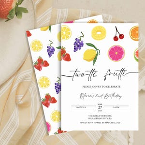 May include: A white invitation with a fruit theme. The invitation says "two-tti frutti" and "Olivia's 2nd Birthday". The invitation has a background of lemons, strawberries, grapes, and cherries.