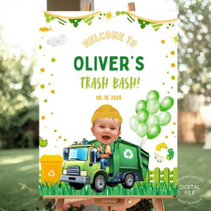 May include: A welcome sign for "Oliver's Trash Bash" with a cartoon image of a baby in a construction hat driving a green garbage truck. The sign includes green balloons, a yellow recycling bin, and the date 08.18.2025.