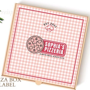 May include: A pink and white gingham pizza box label with the text "Sophia's Pizzeria" in red and black. The logo also includes a chef's hat and a pizza slice. The text "EST 2021" is above the logo. The text "Always Fresh, Always Cute!" is below the logo.