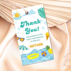 May include: A white tag with a summer theme. It features the text "Thank You!" in teal, along with illustrations of sunglasses, an ice cream cone, a beach ball, and a pineapple. The name "Nathan" is also included.