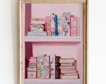 May include: A framed painting of a pink bookshelf filled with books. The books have floral and patterned covers in shades of pink, blue, and white. The frame is gold. The text "ITEMSSY - CRAFTS -" is at the bottom.