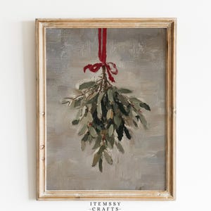 May include: A framed oil painting depicting a bunch of green mistletoe leaves hanging from a vibrant red ribbon. The artwork features visible brushstrokes against a neutral, textured grey background. The text ITEMSSY-CRAFTS appears at the bottom.