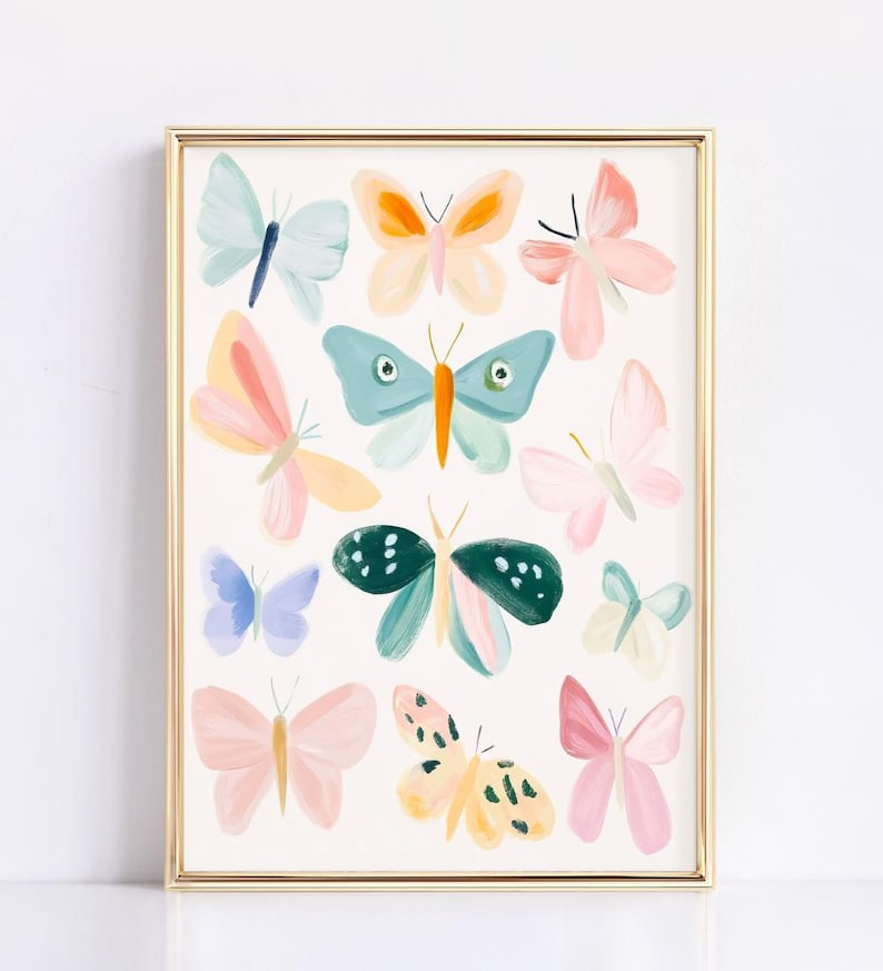 May include: A framed art print featuring a collection of colorful butterfly illustrations. The butterflies are painted in various pastel shades, including pink, blue, yellow, and green, with a gold frame.