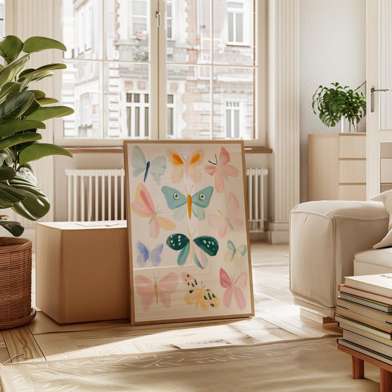 May include: A framed art print featuring watercolor butterflies in various colors, including blue, pink, and orange. The artwork is displayed in a bright, airy room with natural light, a large window, and a wooden floor.