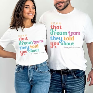 May include: Two white t-shirts with the text "HELLO, WE ARE that dream team they told you about" in colorful letters. The shirts are worn by two people, both wearing blue jeans. The text "Second grade Mr. Irime" and "Second grade Mrs. Came" is also visible.