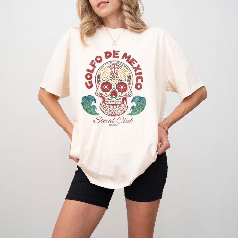 May include: A white t-shirt with a colorful skull graphic and the text "Golfo de Mexico Social Club Est. 1988".