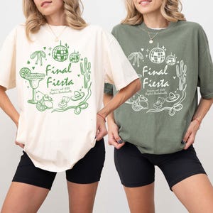 May include: Two women wearing white and green t-shirts with the text "Final Fiesta" and a graphic design of a margarita, a cactus, a disco ball, and a ring. The text also includes "Cannon, est. 2025, Kayla's Bachelorette".