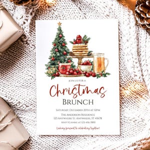 May include: Christmas Brunch invitation with watercolor illustrations of a decorated Christmas tree, pancakes, and a mug of beverage. The invitation text reads "Christmas Brunch" with event details and RSVP information.