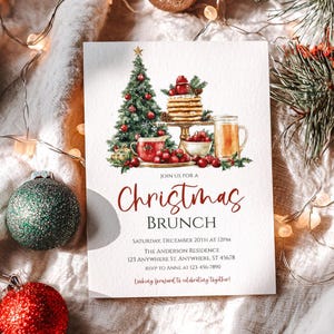 May include: A Christmas brunch invitation with a festive illustration. The design features a Christmas tree, pancakes, and a mug of tea. The invitation text reads "Christmas Brunch" with event details.