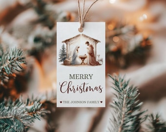 May include: A white Christmas gift tag with a watercolor illustration of the nativity scene. The tag reads "Merry Christmas" and "The Johnson Family".