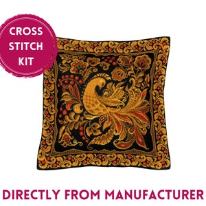 May include: Cross stitch kit featuring a black pillow with a gold and red peacock design. The pillow is surrounded by a gold and red floral border.