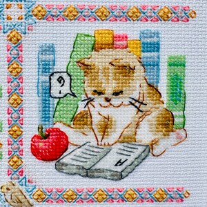 The RIOLIS cross stitch kit Cat Calendar features a charming calendar design with cats, using 29 colors of wool/acrylic threads. The kit includes a needle, Zweigart 14ct white AIDA fabric, and a color chart. The finished size is 30x40 cm.
