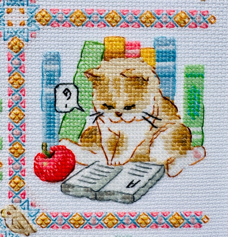 The RIOLIS cross stitch kit Cat Calendar features a charming calendar design with cats, using 29 colors of wool/acrylic threads. The kit includes a needle, Zweigart 14ct white AIDA fabric, and a color chart. The finished size is 30x40 cm.