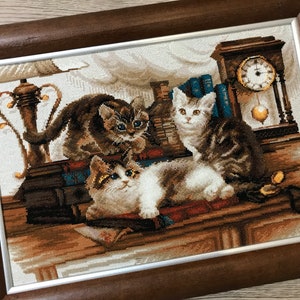 The RIOLIS cross stitch kit Furry Friends features beautiful three kittens playing. The kit includes wool acrylic threads in 20 colors, a needle, Zweigart 14ct flaxen AIDA fabric and a color chart. The finished size is 40x30 cm