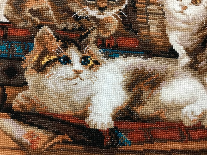 The RIOLIS cross stitch kit Furry Friends features beautiful three kittens playing. The kit includes wool acrylic threads in 20 colors, a needle, Zweigart 14ct flaxen AIDA fabric and a color chart. The finished size is 40x30 cm
