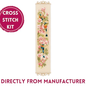 May include: Cross stitch kit featuring a vertical design of pink flowers and blue birds on a beige background. The kit includes all the materials needed to complete the project.