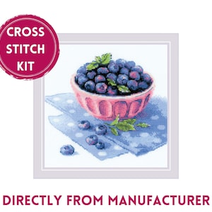 May include: A cross stitch kit featuring a bowl of blueberries on a blue and white patterned napkin. The bowl is pink with a white rim. The blueberries are a dark blue color. The kit includes all the materials needed to complete the cross stitch project.
