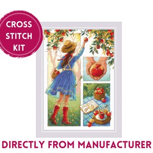 May include: Cross stitch kit featuring a girl picking apples from a tree. The kit includes a colorful image of a girl in a blue dress and red boots, a basket of apples, and a picnic scene with a book, apples, and a glass of juice. The kit is titled "Cross Stitch Kit".