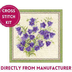 May include: Cross stitch kit featuring a floral design of purple bellflowers in a green frame. The kit includes all the materials needed to complete the project.