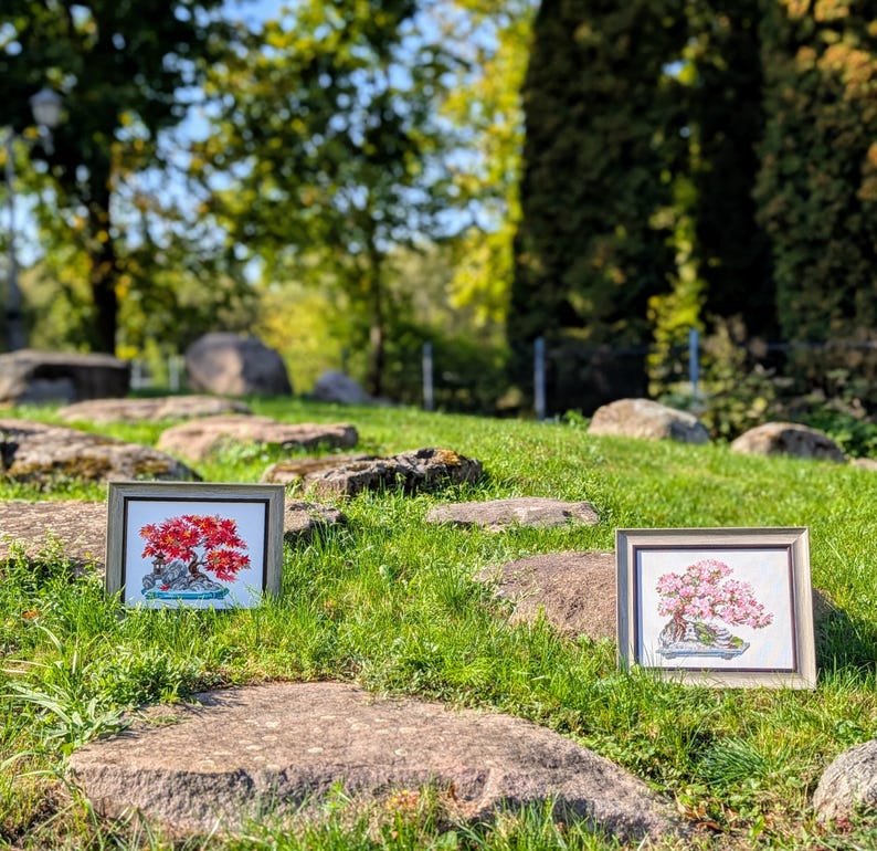 The RIOLIS cross stitch kit Flowering Bonsai features a delicate bonsai design using 17 colors of wool/acrylic threads. The kit includes a needle, Zweigart 14ct white AIDA fabric, and a color chart. The finished size is 30x24 cm (11¾in x 9½in).