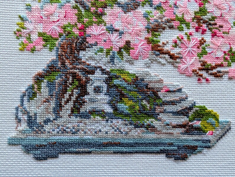 The RIOLIS cross stitch kit Flowering Bonsai features a delicate bonsai design using 17 colors of wool/acrylic threads. The kit includes a needle, Zweigart 14ct white AIDA fabric, and a color chart. The finished size is 30x24 cm (11¾in x 9½in).