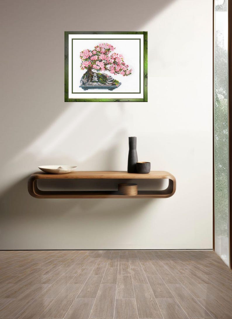 The RIOLIS cross stitch kit Flowering Bonsai features a delicate bonsai design using 17 colors of wool/acrylic threads. The kit includes a needle, Zweigart 14ct white AIDA fabric, and a color chart. The finished size is 30x24 cm (11¾in x 9½in).