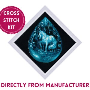 May include: Cross stitch kit featuring a white unicorn in a blue teardrop-shaped design. The unicorn is surrounded by a forest scene with stars and a crescent moon. The kit includes all the materials needed to complete the project.