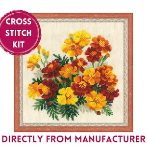 May include: Cross stitch kit featuring a bouquet of orange, yellow, and red marigolds in a white frame with a red border. The kit includes all the materials needed to complete the project. "Cross Stitch Kit" is written in a red circle at the top left of the image.