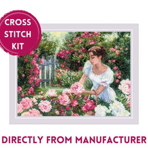 May include: Cross stitch kit featuring a woman in a white dress standing in a garden with pink and white flowers. The kit includes all the materials needed to complete the project.