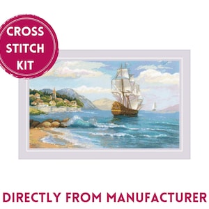 May include: Cross stitch kit featuring a sailboat with white sails on a blue ocean with a small town on the shore. The kit includes all the materials needed to complete the project.