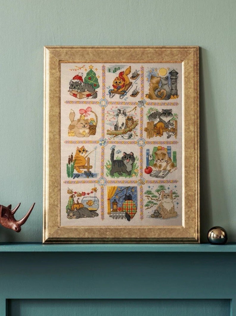 The RIOLIS cross stitch kit Cat Calendar features a charming calendar design with cats, using 29 colors of wool/acrylic threads. The kit includes a needle, Zweigart 14ct white AIDA fabric, and a color chart. The finished size is 30x40 cm.