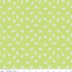 May include: Lime green fabric with a repeating pattern of small floral clusters. Each cluster features pink and light blue flowers with white outlines. The fabric is marked with inches.