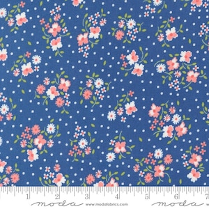 May include: Blue fabric with a white polka dot pattern and a small pink floral print. The fabric is marked with a ruler in inches.
