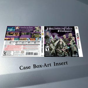 May include: A Nintendo 3DS game case insert for "Fire Emblem Fates: Conquest." The cover features a group of anime-style characters in shades of gray and blue. The back of the case has text in English and French.