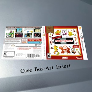 May include: A Nintendo 3DS game case insert for "Ultimate NES Remix." The cover is red and white with pixelated character graphics. The back features screenshots and game details. The text "Case Box-Art Insert" is at the bottom.