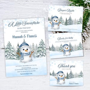 Puede incluir: Juego de invitaciones para baby shower con un muñeco de nieve de acuarela con gorro y bufanda azules, sobre un fondo de bosque nevado. La invitación dice "A Little Snowflake is on the Way!" con detalles para el baby shower de Hannah & Francis.