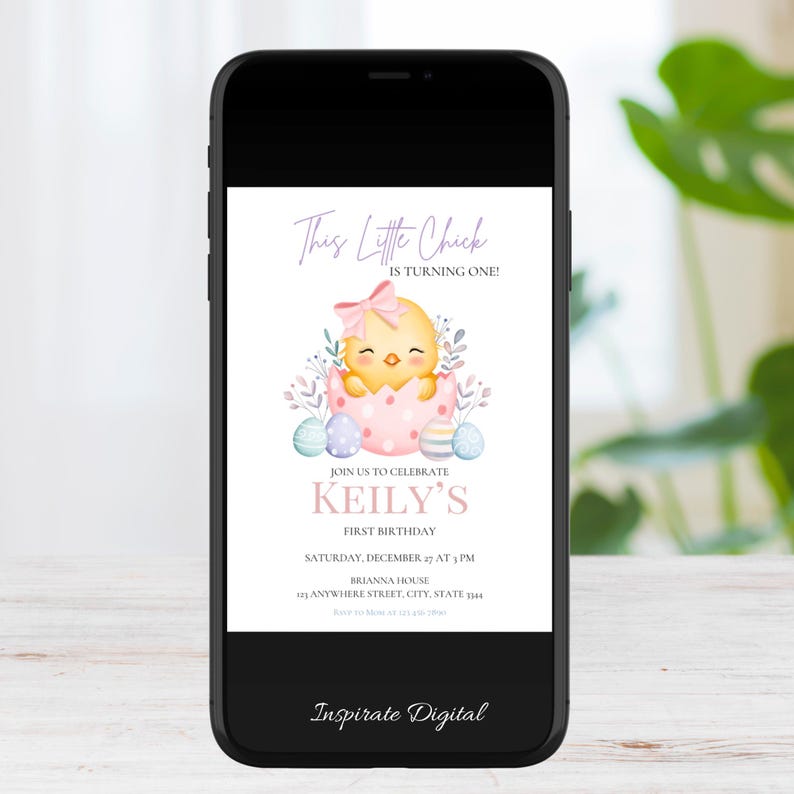 May include: A smartphone displays a digital invitation for a first birthday. The invitation features a watercolor illustration of a yellow chick hatching from a pink egg, surrounded by pastel Easter eggs and foliage. Text reads "This Little Chick is Turning One!" and details for the party.