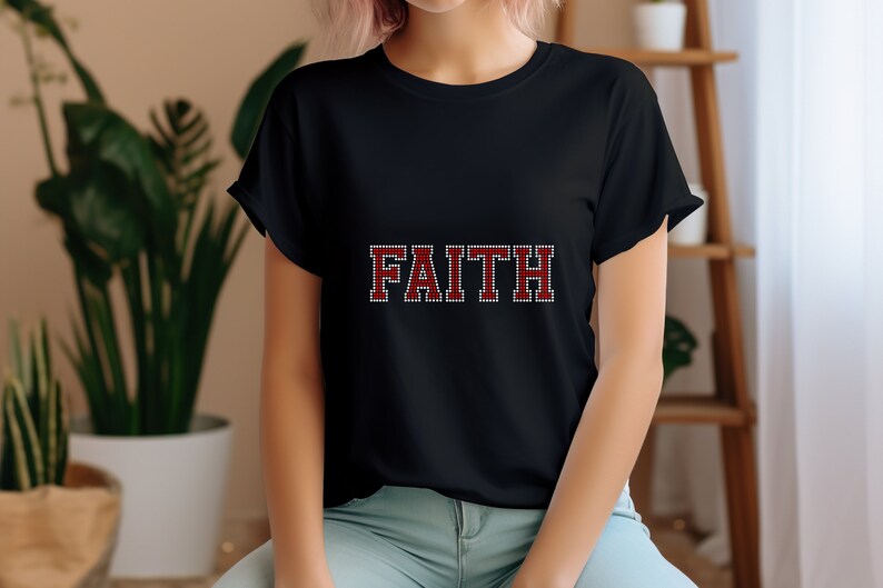 May include: Black t-shirt with the word "FAITH" in red and white rhinestones.