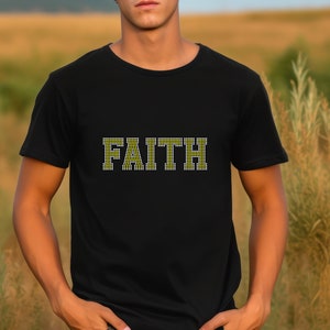 May include: A black t-shirt with the word "FAITH" spelled out in yellow and white rhinestones.