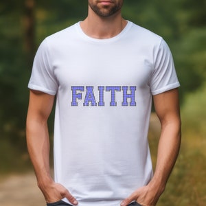 May include: A white t-shirt with the word "FAITH" printed in blue and white checkered letters.